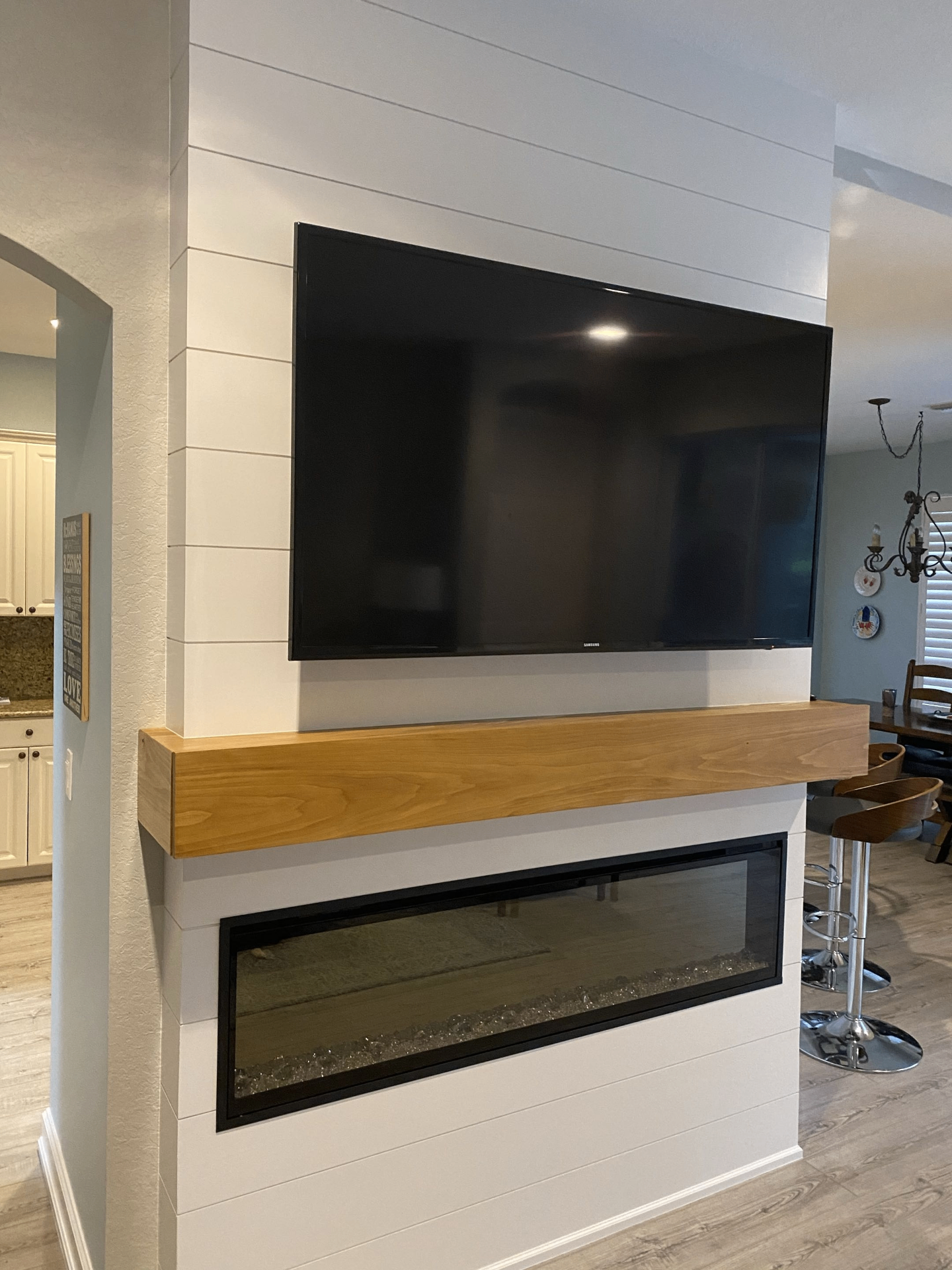 Shiplap fireplace feature wall with floating wood mantel